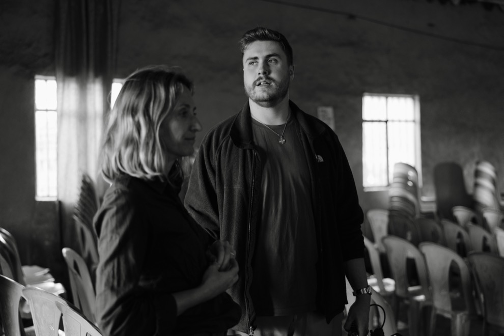 Matt and a colleague inside a rural church between setups, black and white